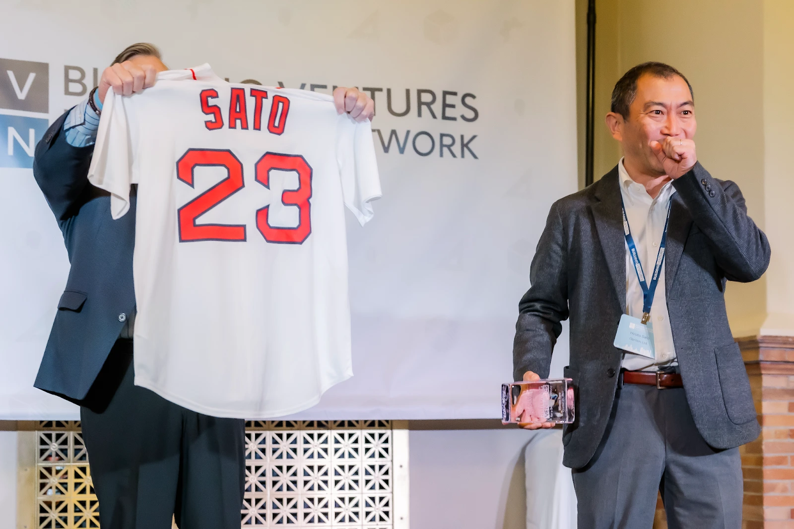 Jesse Devitte presenting Oprizon CEO Hiroto Sato with a personalized Red Sox Jersey at BVIN Fall 2023